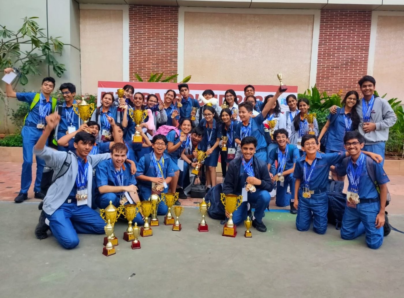 The Hill Spring team posing with a row of gold trophies