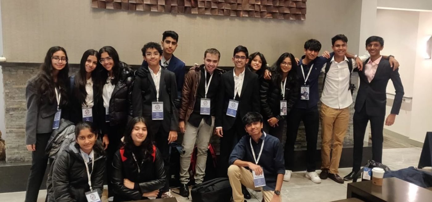 A group of delegates in formal wear with lanyards